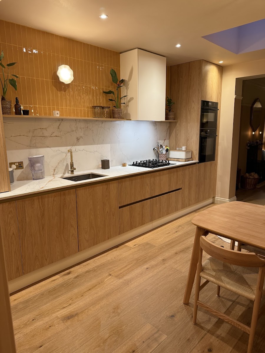 Modern fitted kitchen with oak units, marble worktop and mustard tiles by A1 Handyman Dublin